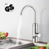 A kitchen faucet with hot water steaming into a sink, with a bowl of fruit and vegetables nearby. Podgląd zdjęcia produktu