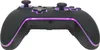 A black game controller with purple LED lighting. Voir les images du produit