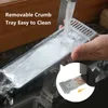 A person is rinsing a removable crumb tray under running water in a sink. Produktbild-Vorschau