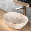 A close-up view of a stone-like basin with a modern faucet in a bathroom setting. Náhľad obrázku produktu