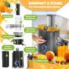 A product image showing a juicer with its components labeled and a person's hand operating it, surrounded by oranges and juice. Produktbild-Vorschau