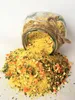 A glass jar of seasoning is tipped over, spilling its contents onto a white surface. Podgląd zdjęcia produktu