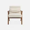 A cream-colored armchair with a wooden frame and a small pillow on a white background. Anteprima dell’immagine prodotto