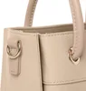 A close-up view of the top corner of a beige handbag, showing the stitching and hardware. Podgląd zdjęcia produktu
