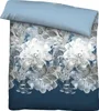 A folded duvet cover and pillowcase with a floral pattern. Produktbild-Vorschau
