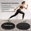 Schwarze HURDILEN Trainings-Slider auf einem Holzboden, mit einer Frau, die sie für eine Ausfallschrittübung verwendet Podgląd zdjęcia produktu