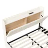 A close-up view of a white upholstered bed frame with a wooden headboard and integrated lighting and charging ports. Podgląd zdjęcia produktu