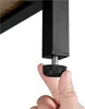 A hand is shown adjusting the leveling foot on the leg of a piece of furniture. Podgląd zdjęcia produktu