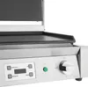 A close-up view of the control panel and cooking surface of a commercial grill. Náhled obrázku produktu