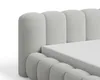 Close-up of a light gray bouclé fabric upholstered bed frame. Voir les images du produit