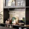 A well-organized home bar or kitchen cabinet setup, showcasing a high cabinet with glass doors, a wine glass rack, and various items on the countertop. Produktbild-Vorschau