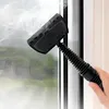 A hand holds a steam cleaner attachment to a window. Náhled obrázku produktu