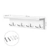 A white coat rack with four hooks is displayed on a white background with dimensions and mounting hardware shown. Produktbild-Vorschau