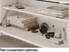Close-up view of shelves with various items, including books, headphones, sunglasses, and a candle. Produktbild-Vorschau