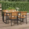An outdoor dining set with a wooden table and chairs on a wooden deck, with a green hedge in the background. Produktbild-Vorschau