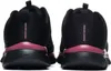 The back view of two black Skechers women's sneakers with pink accents. Voir les images du produit
