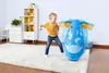 A young girl is playing with a blue inflatable elephant bop bag in a child's room. Produktbild-Vorschau
