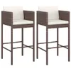Two brown poly rattan bar stools with white cushions are shown against a white background. Náhľad obrázku produktu