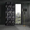 A dark, luxurious room with a patterned curtain and a floor lamp. Produktbild-Vorschau
