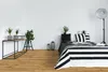 A bedroom with a bed, console table, and plants. Produktbild-Vorschau