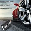 A car tire and wheel with a red car body in the background, and a portable tire inflator in the foreground. Produktbild-Vorschau