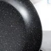 A close-up view of the speckled interior of a black frying pan. Produktbild-Vorschau