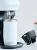A white Contigo travel mug is being filled with coffee from a coffee maker. A black lid is placed next to the mug. Náhľad obrázku produktu