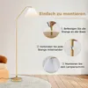 An instructional image showing the assembly steps for a gold floor lamp. Podgląd zdjęcia produktu