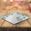 A digital kitchen scale is displayed on a wooden table. Produktbild-Vorschau