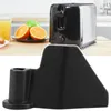 A black bread maker paddle is shown in the foreground, with a toaster and fruit in the background. Produktbild-Vorschau