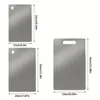 Three stainless steel cutting boards of different sizes are displayed with dimensions indicated. Produktbild-Vorschau