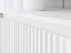 A close-up, angled view of a white fluted cabinet door, likely part of a TV stand or cabinet. Náhľad obrázku produktu