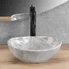 A close-up shot of a grey marble basin with a black faucet on a wooden countertop. Podgląd zdjęcia produktu