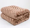 A folded brown blanket with a chevron pattern. Podgląd zdjęcia produktu