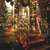 A decorated storefront with a Christmas tree and lights. Produktbild-Vorschau