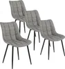 Four gray upholstered dining chairs with black metal legs are arranged in a staggered formation against a white background.