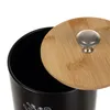 A close-up view of the top part of a black storage container with a bamboo lid and a silver knob. Náhľad obrázku produktu