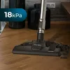 A vacuum cleaner head is shown on a wooden floor, with dirt being picked up. Produktbild-Vorschau