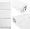 A collage showing a white dresser and two rolls of white adhesive film. Produktbild-Vorschau