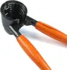 A close-up shot of a nutcracker with black metal jaws and orange wooden handles. Podgląd zdjęcia produktu
