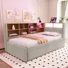 A bedroom scene featuring a light gray upholstered daybed with a built-in wooden bookshelf headboard. The bookshelf is decorated with framed art and decorative items, and illuminated by pink LED lights. A tablet is placed on top of the headboard. Náhled obrázku produktu