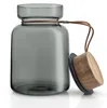 A glass storage jar with a wooden lid and a leather strap. Produktbild-Vorschau