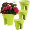 A set of lime green balcony planters, one filled with red and pink flowers. Produktbild-Vorschau