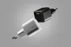 Two power adapters, one white and one black, are shown floating against a gray background. Podgląd zdjęcia produktu