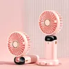 Two pink portable fans are displayed on a pink background with vertical stripes. Náhled obrázku produktu