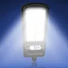 A close-up of a solar-powered LED outdoor light with a motion sensor, emitting a bright light against a blue gradient background. Náhľad obrázku produktu