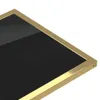 A close-up view of a corner of a black table with a gold frame. Podgląd zdjęcia produktu