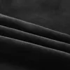 A close-up view of black fabric with visible folds and texture. Podgląd zdjęcia produktu