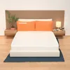 A bed with a mattress, pillows, and a headboard, set up in a bedroom. Produktbild-Vorschau