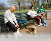 People and a dog in a park with a large inflatable bunny. Produktbild-Vorschau